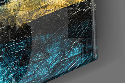 Close-up angled view of glass wall art with gold top edge, black middle section, and turquoise-blue textured lower portion with white highlights.