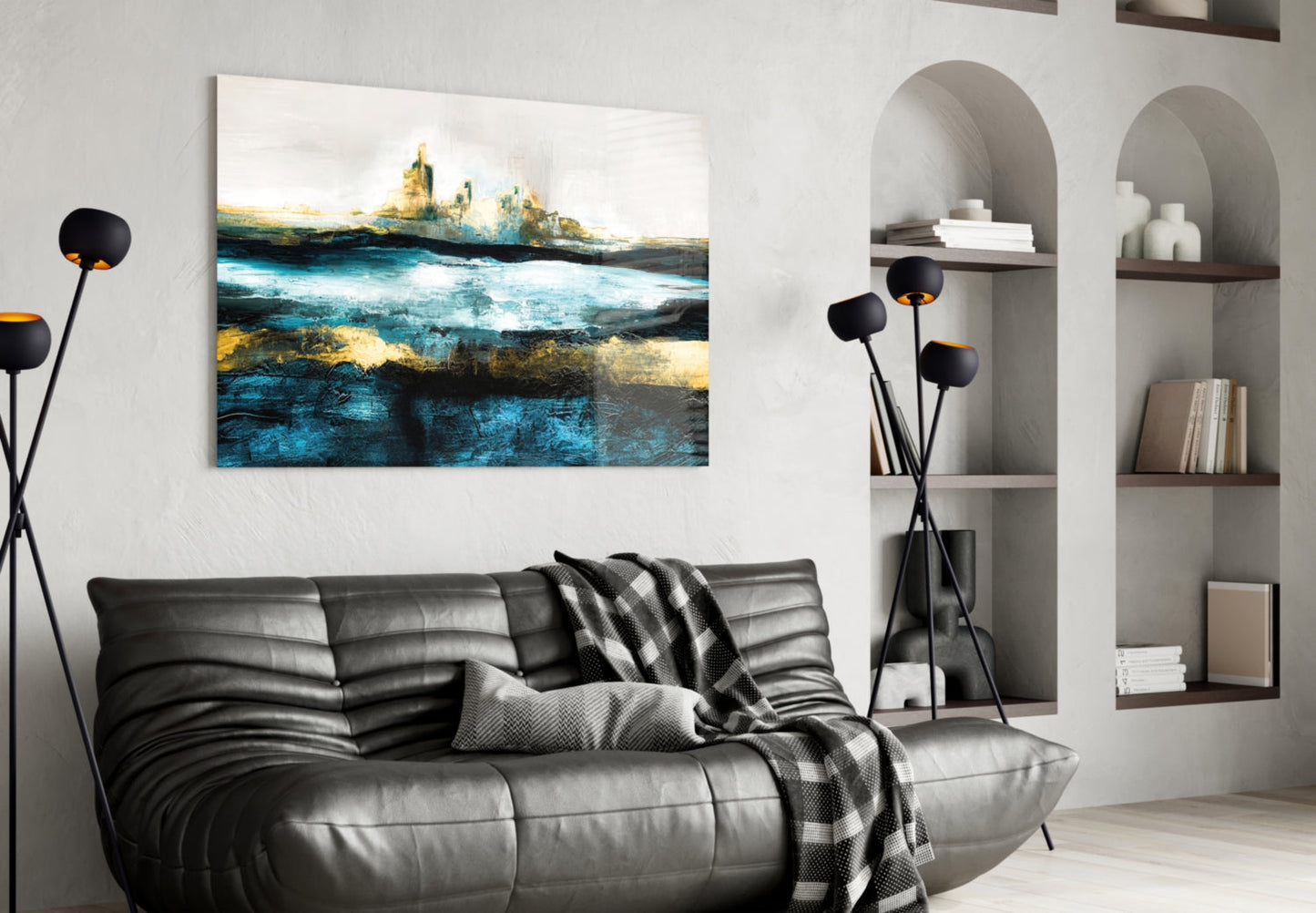 Modern living room interior featuring Sea of a Dream glass wall art with blue, gold, and black landscape design above gray leather sofa.