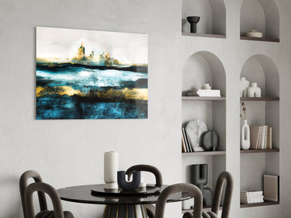 Abstract seascape glass art with turquoise, gold, and dark tones displayed above dining table in modern interior.