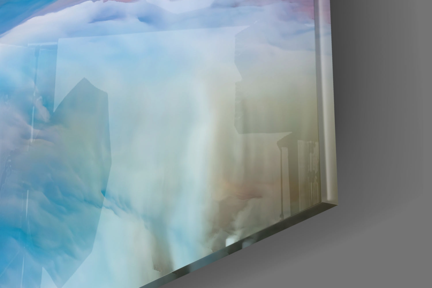 Angled side view of glass wall art displaying misty cityscape with blue sky and tall buildings in soft focus.