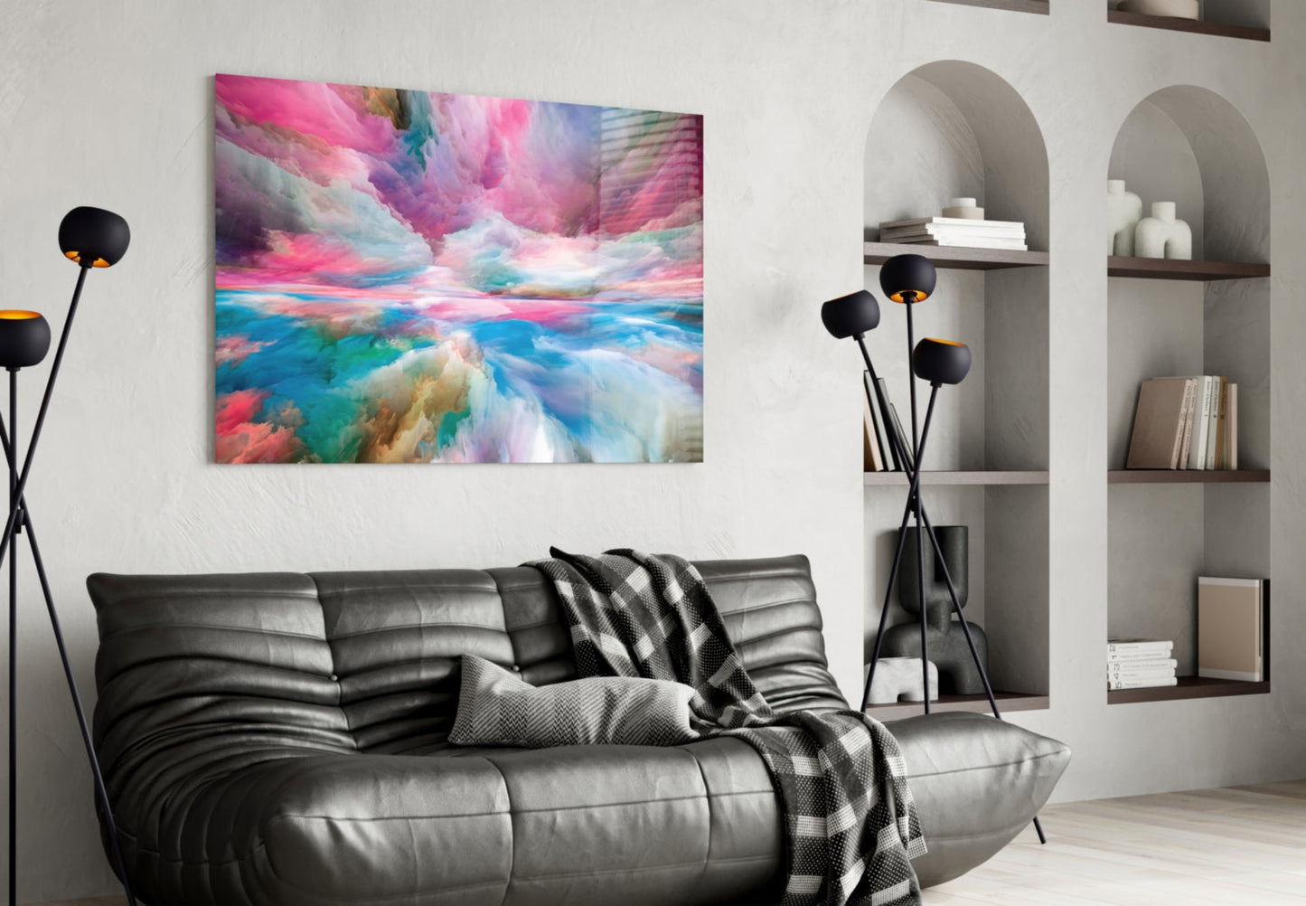 Modern living room with black leather sofa displaying colorful abstract glass wall art above it, flanked by white shelving and black floor lamp.