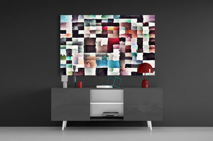 Modern living room setup displaying colorful abstract glass wall art above gray media console with red decorative objects.