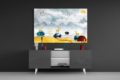 Framed glass wall art displaying stylized golden deer, mountains, and birds above modern TV stand in living room setting.