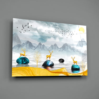 Modern glass wall art featuring golden deer on turquoise stones, misty mountains, and yellow sand in an angled perspective view.