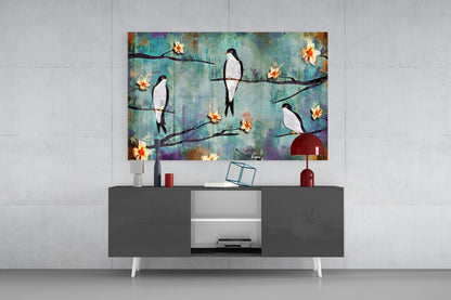 Birds of a Dream glass wall art displayed above a dark gray and white media console, showing colorful birds perched on branches with yellow flowers against a blue-green textured background.