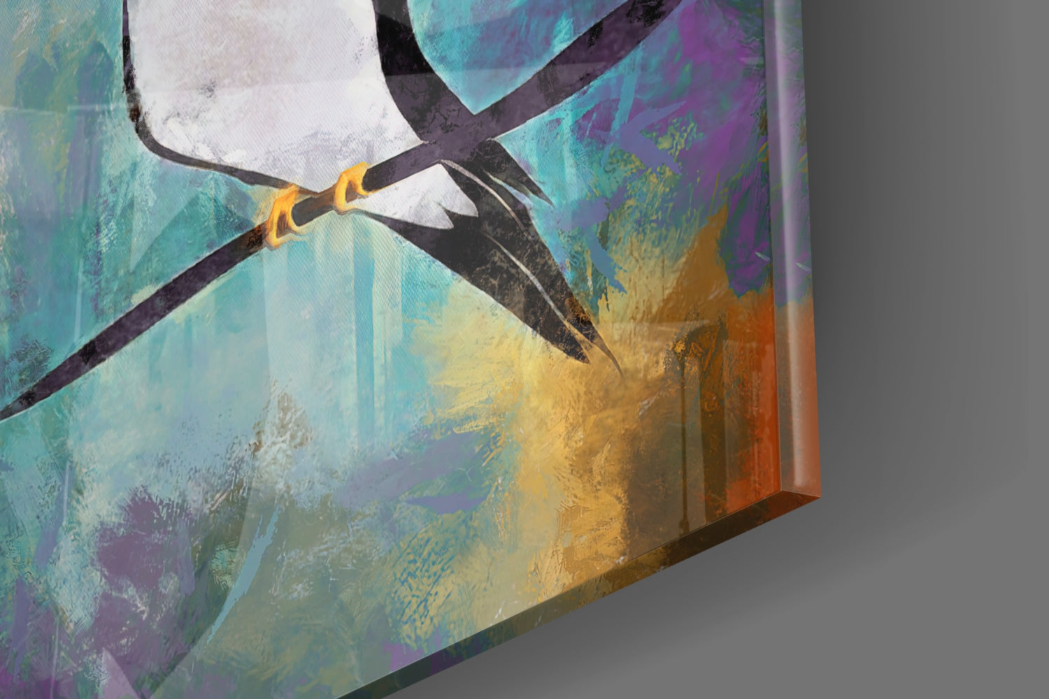 Close-up angled view of glass art showing stylized black bird with gold band against turquoise, purple, yellow, and orange watercolor background.
