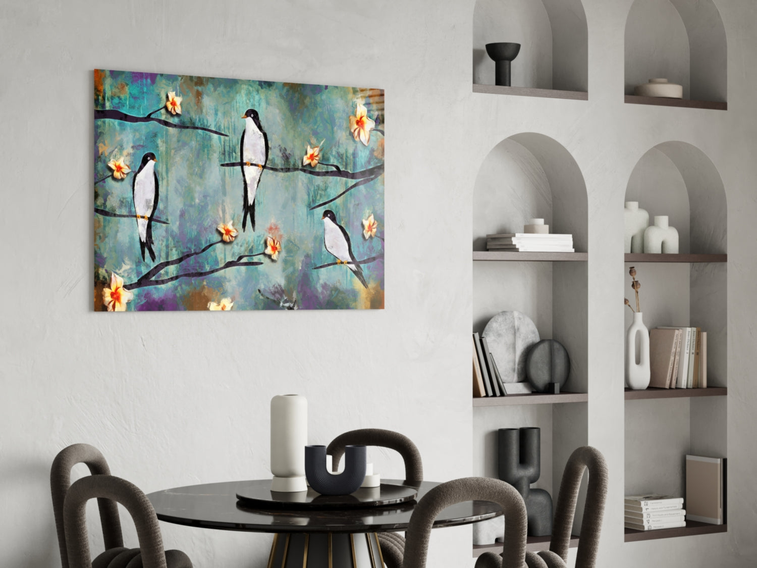 Colorful glass wall art depicting black and white birds perched on branches with yellow flowers against a blue and purple textured background, displayed above a round black dining table.