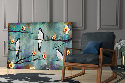 Birds of a Dream glass wall art displayed in modern living room with wooden chair, showing birds perched on branches with yellow flowers against turquoise textured background.