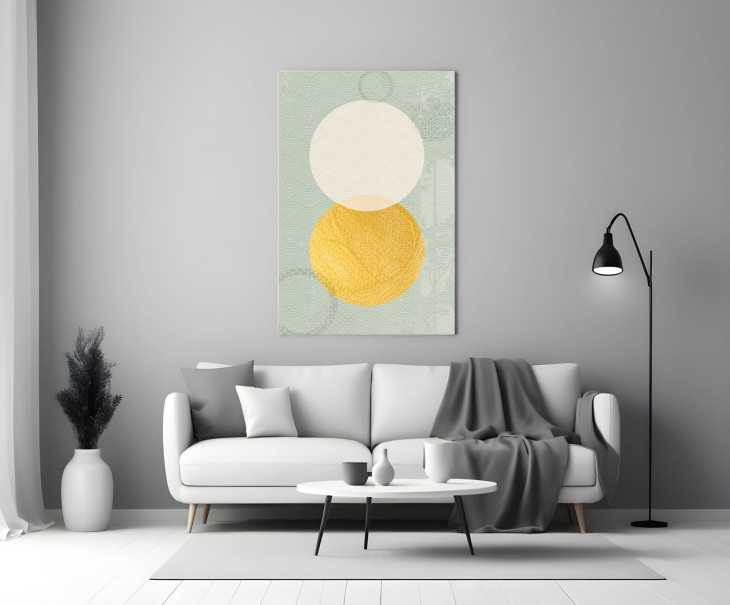 Sun and Moon Glass Wall Art displayed above a white sofa in a minimalist living room setting with sage green patterned background, cream circle, and golden yellow circle.