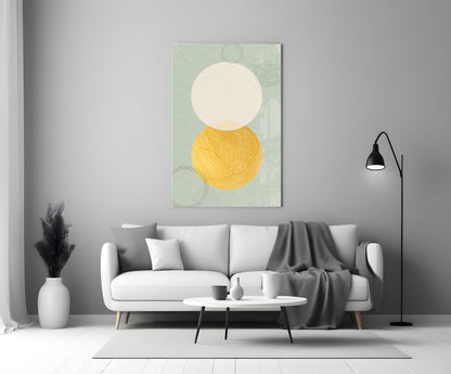 Sun and Moon Glass Wall Art displayed above a white sofa in a minimalist living room setting with sage green patterned background, cream circle, and golden yellow circle.