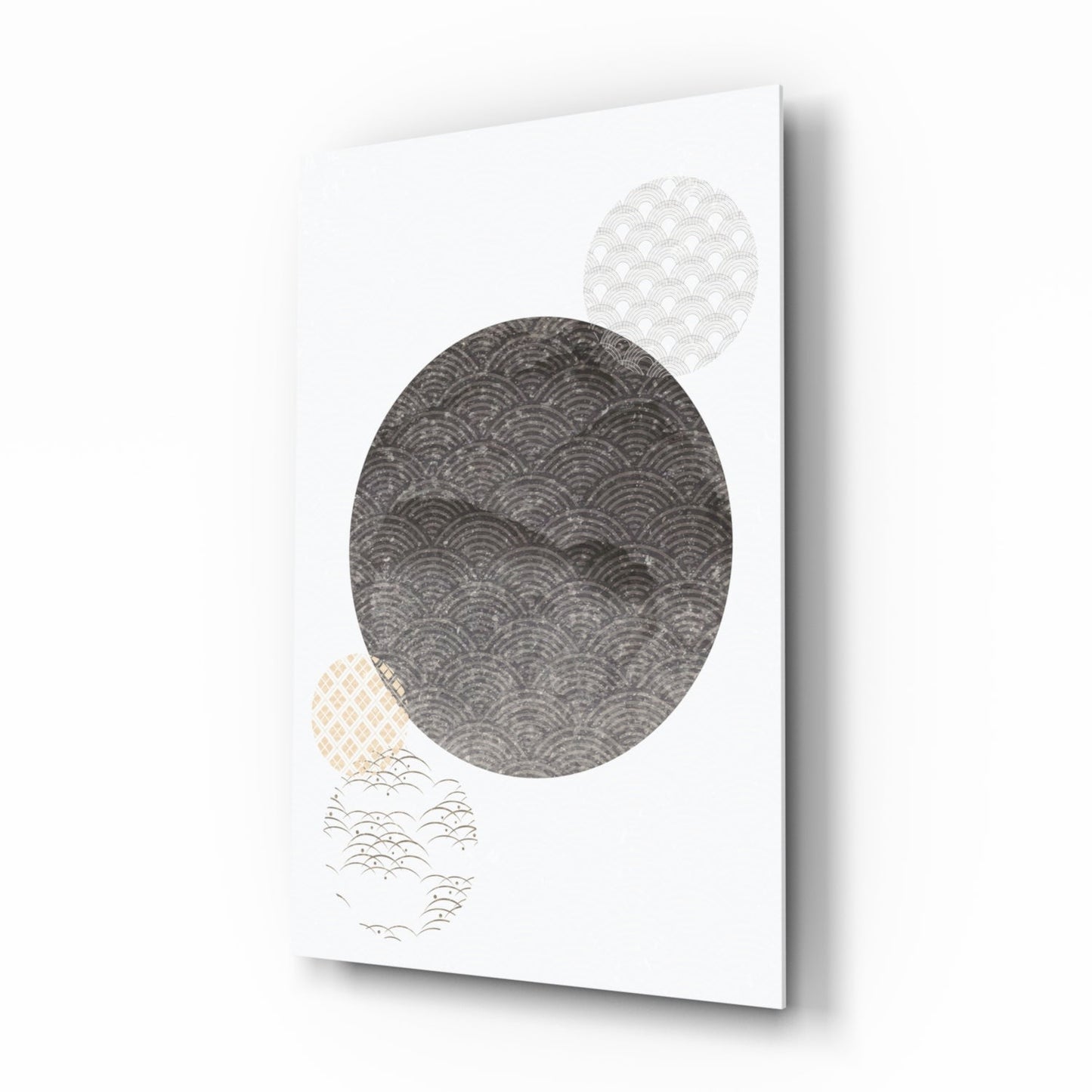 Angled view of Black Moon Glass Wall Art showing three patterned circles in gray, beige, and white against white background.