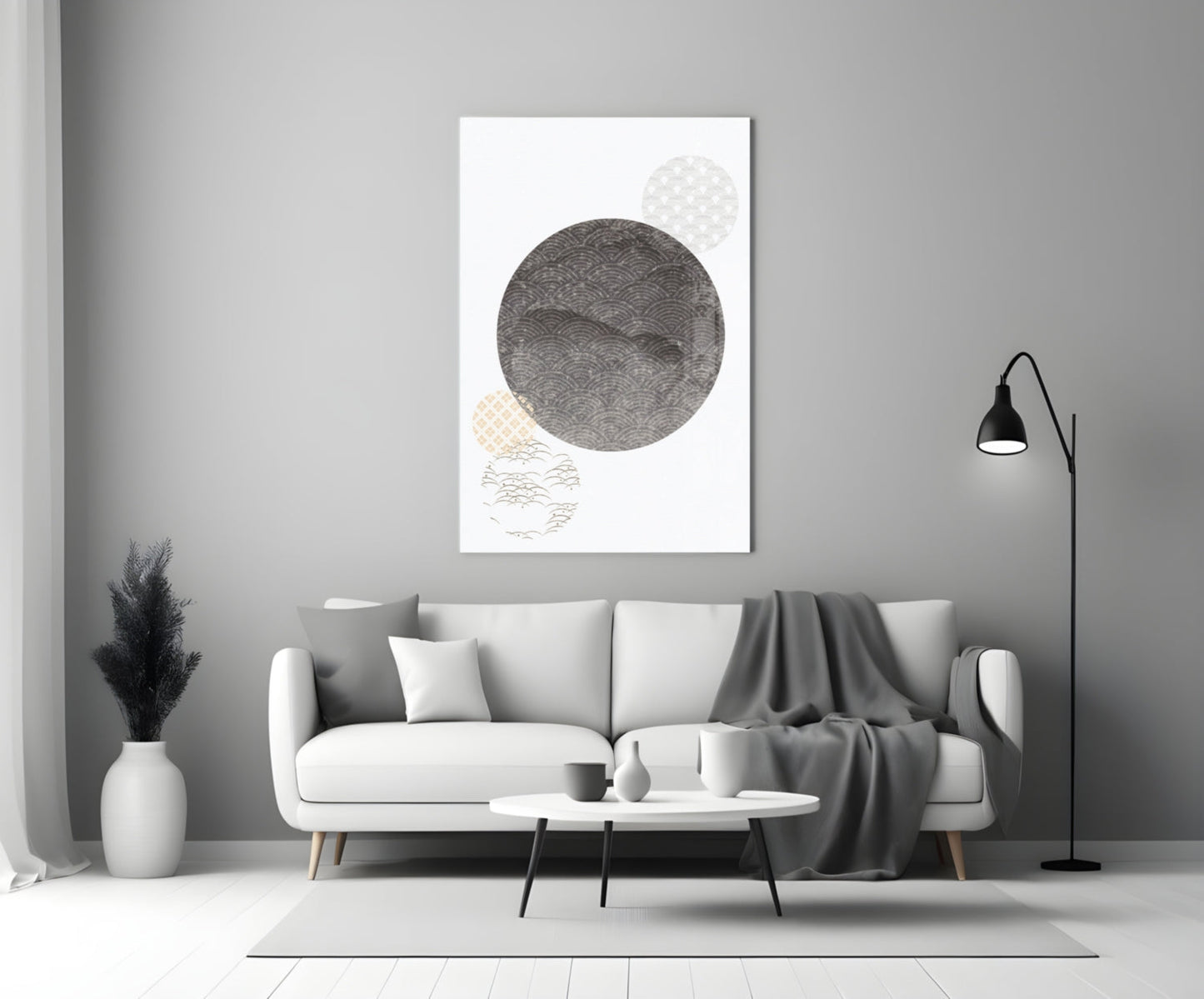 Black Moon Glass Wall Art displayed above a white sofa in a minimalist living room interior with gray accents.