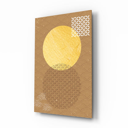 Angled view of gold patterned glass wall art featuring a large yellow oval circle centered on a tan background with geometric patterns.