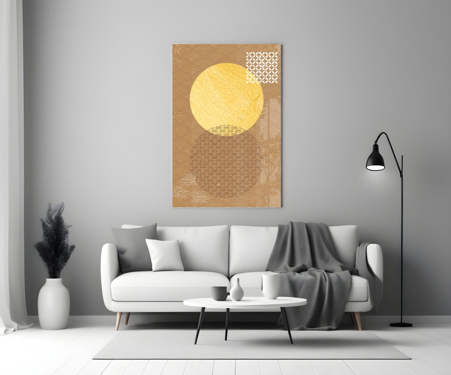Gold-toned glass wall art with a large yellow circular sun and geometric patterns displayed above a white sofa in a modern living room.