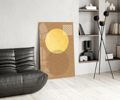 Modern living room interior with gold and cream "Shadow of the Sun" wall art displayed beside black leather chair and decorative shelving.