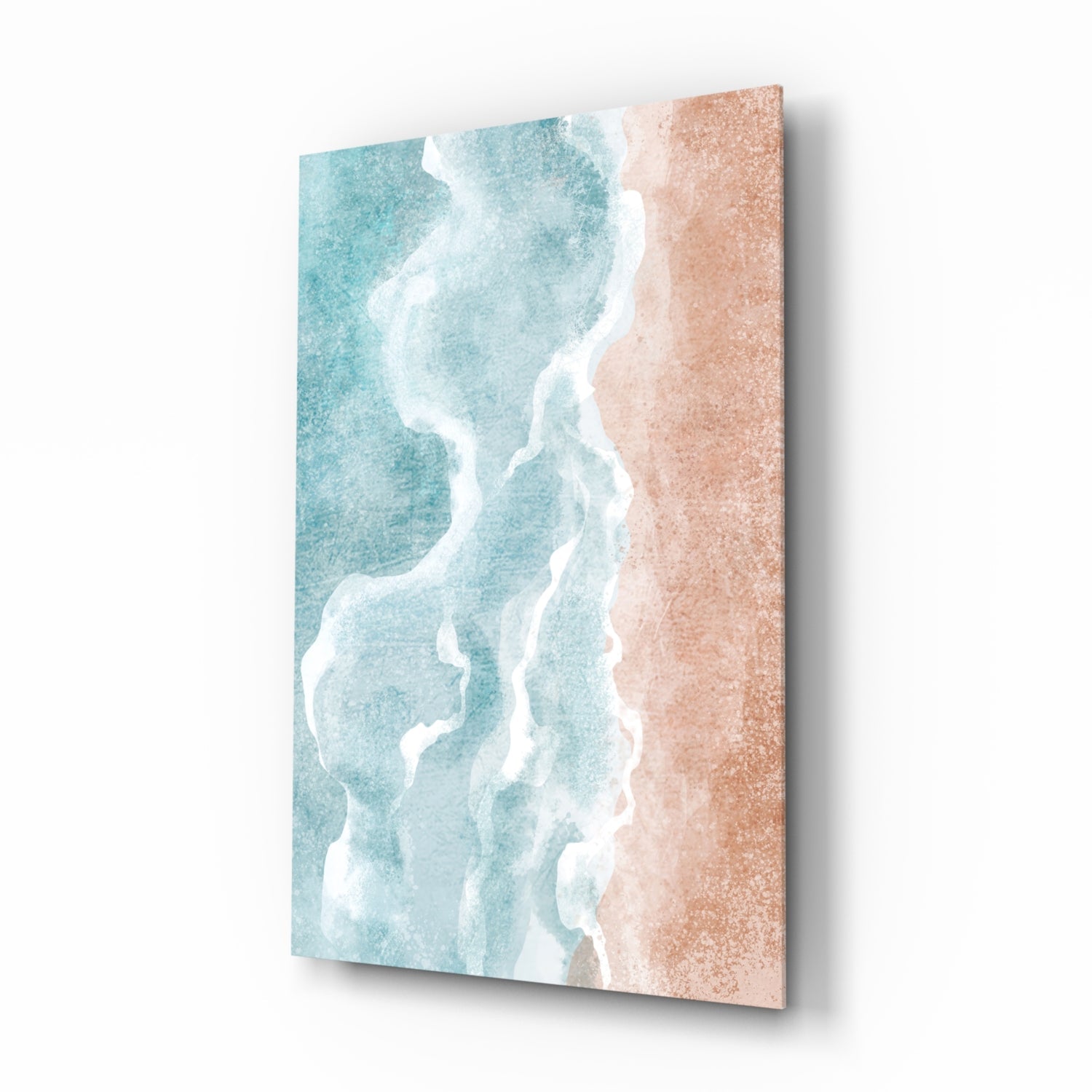 Angled three-quarter view of a canvas wall art depicting turquoise ocean waves with white foam meeting a sandy beach shore.