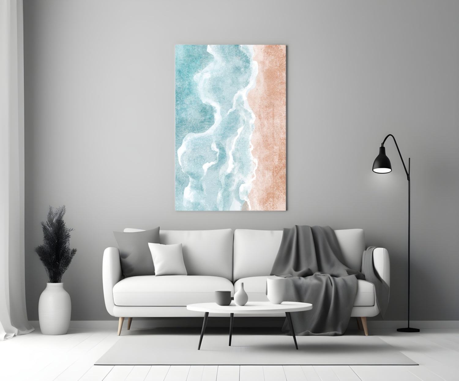 Beach glass wall art depicting turquoise ocean waves and white foam on sandy beach displayed above white sofa in modern living room.