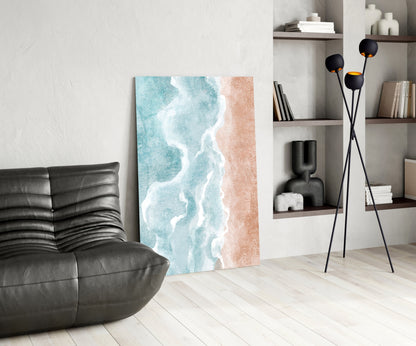 Beach-themed canvas artwork featuring turquoise ocean waves and sandy beach in modern living room setting with black furniture and shelving.