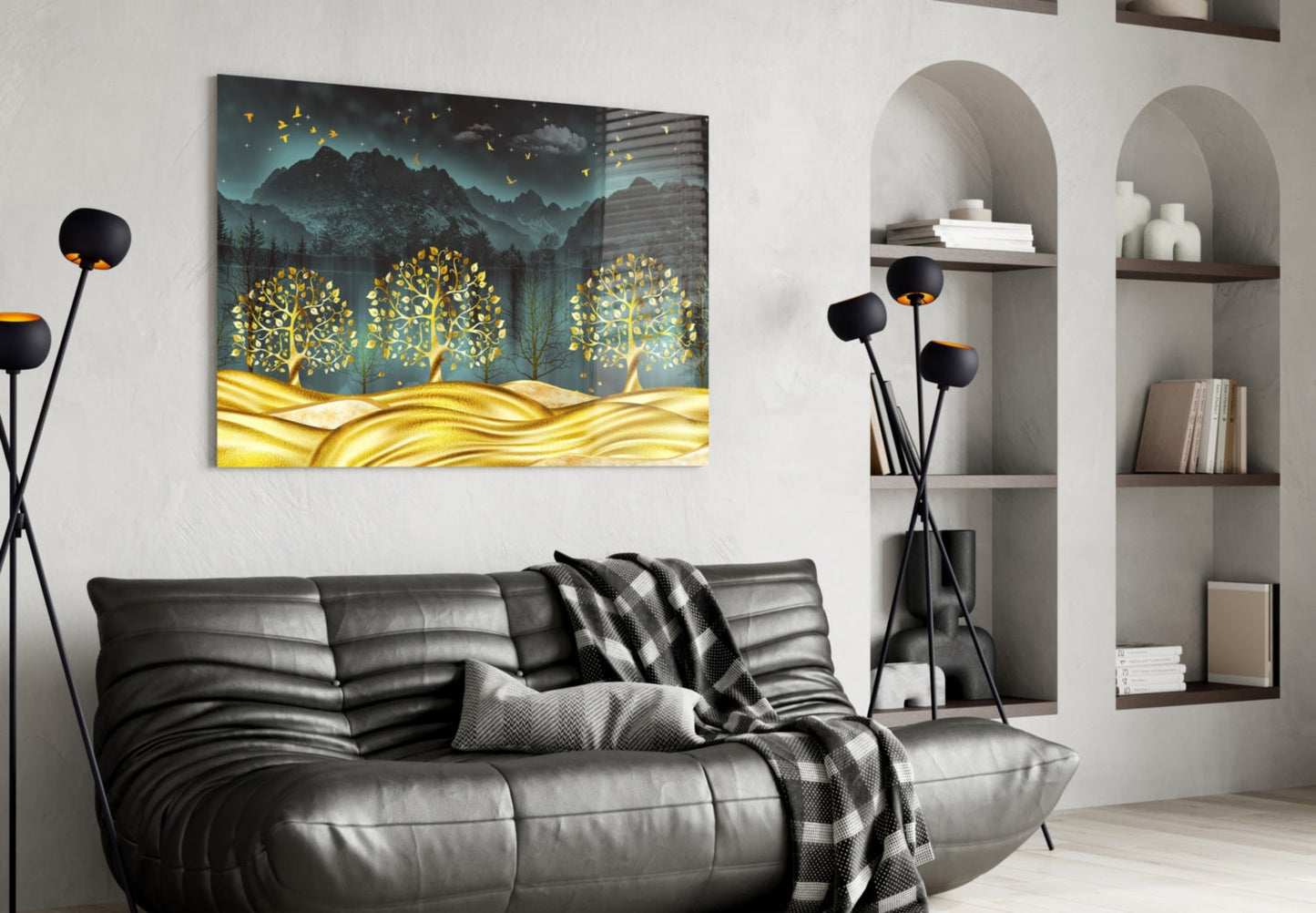 Golden Forest Glass Wall Art hanging above a black leather sofa in a modern living room with white arched shelving.