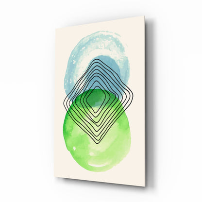 Glass wall art displaying layered geometric shapes in blue, green, and black lines on cream background, angled product view.