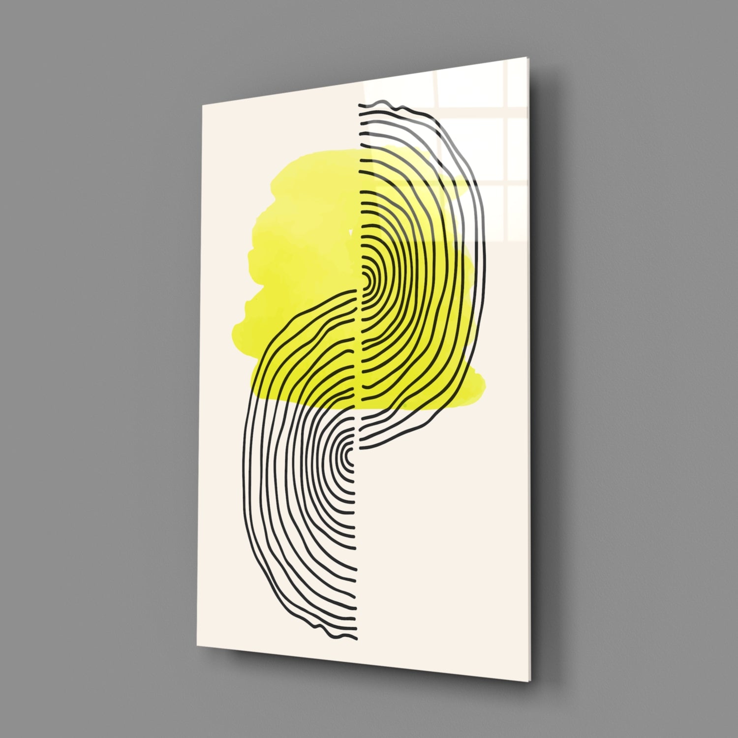 Angled view of glass wall art featuring a neon yellow silhouette with concentric black line pattern on cream background.