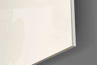 Close-up angled view of frosted glass wall art with subtle geometric design casting soft shadows on gray surface.