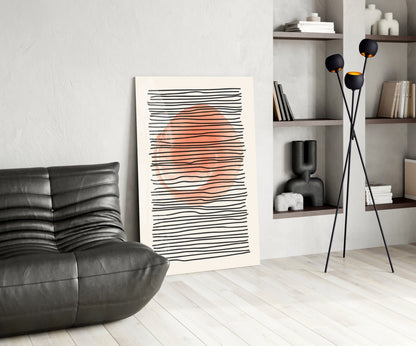 Modern living room interior featuring abstract wall art with black horizontal lines and coral orange center, displayed next to black leather furniture and tall floor lamp.