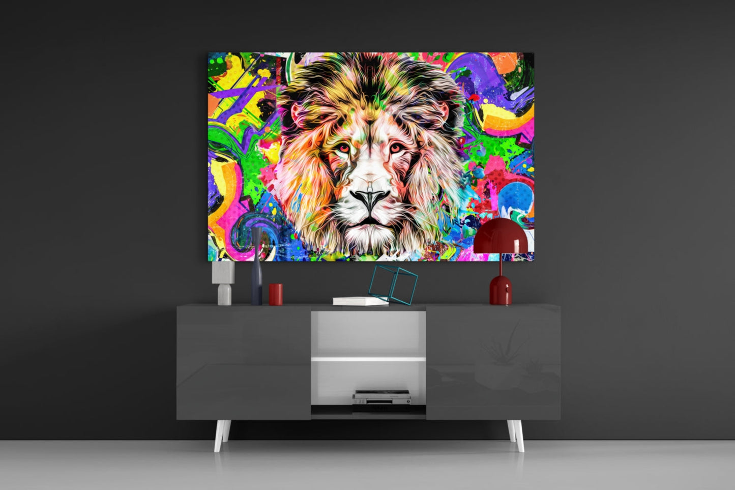 Colorful lion glass wall art displayed above a modern gray media console with white legs and red decorative accessories.