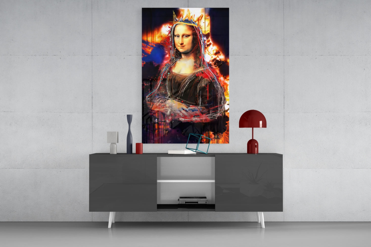 Modern living room display showing Queen Mona Lisa glass wall art with vibrant fire and crown effects mounted above gray console table with red lamp.