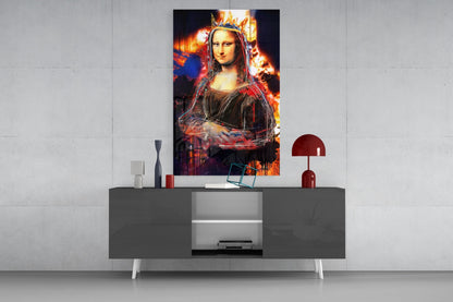 Modern living room display showing Queen Mona Lisa glass wall art with vibrant fire and crown effects mounted above gray console table with red lamp.
