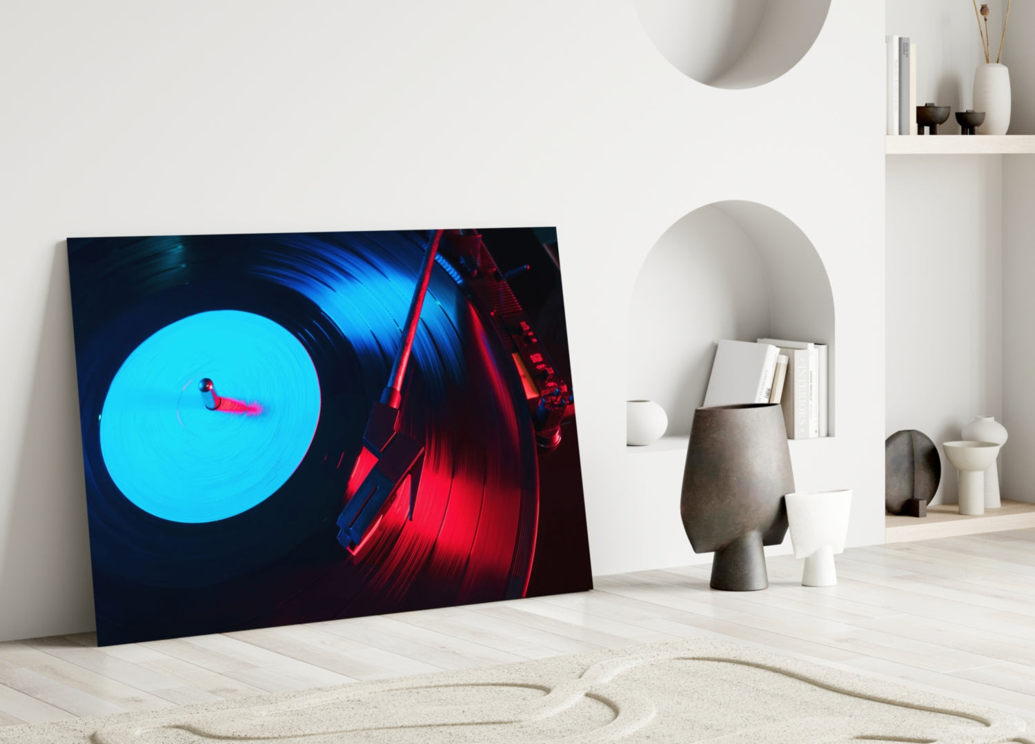 Gramophone glass wall art leaning against white wall displaying cyan vinyl record and red turntable on dark background.