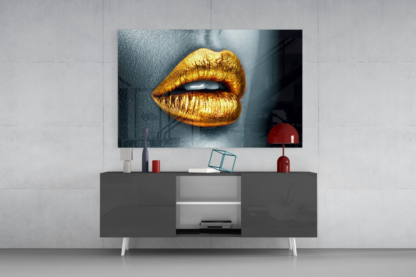 Golden lips glass wall art displayed above a modern media console in a contemporary living room setting.