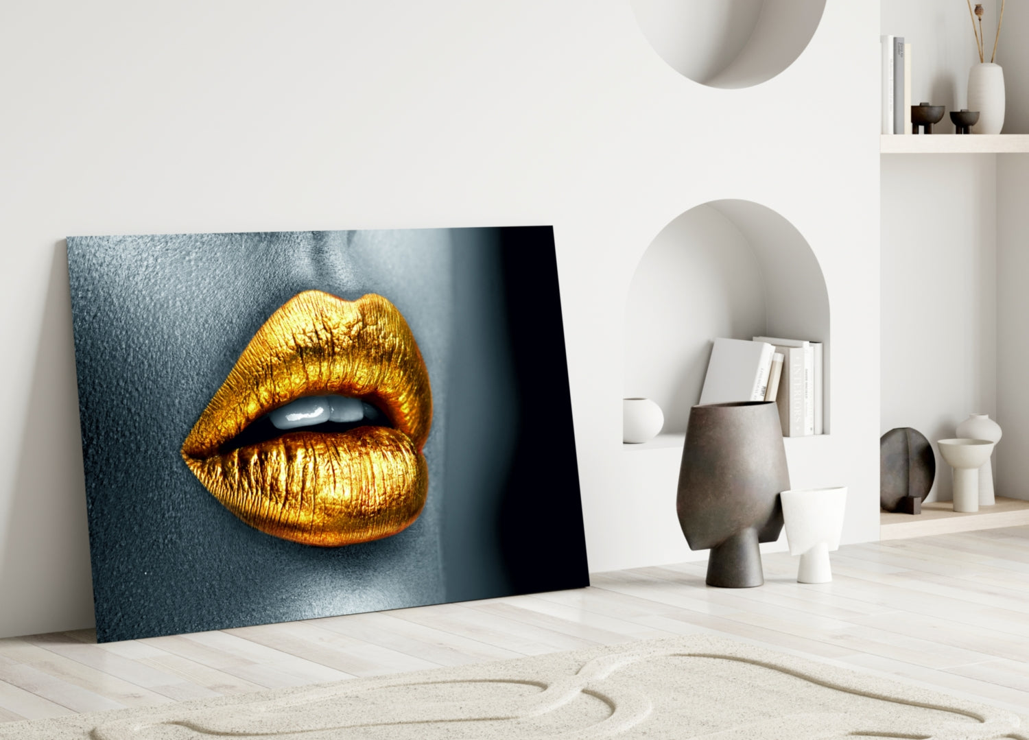 Golden lips glass wall art leaning against white wall in minimalist interior with shelving and decorative objects.