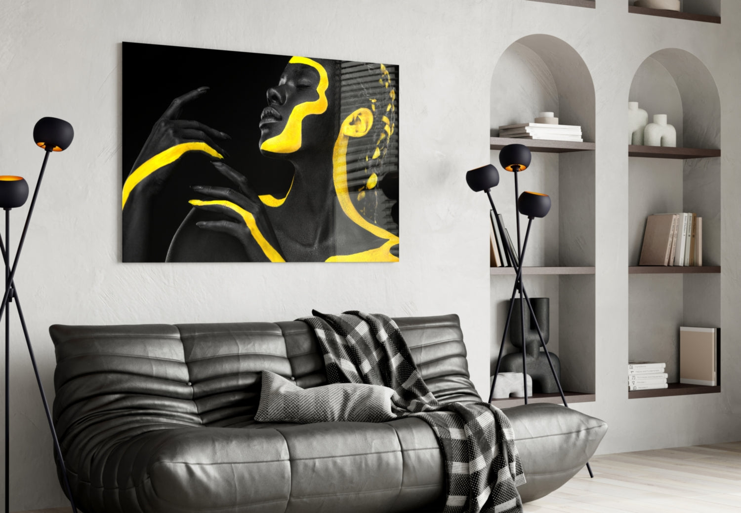Yellow Woman Glass Wall Art displayed above a black leather sofa in a modern living room setting with built-in shelving.