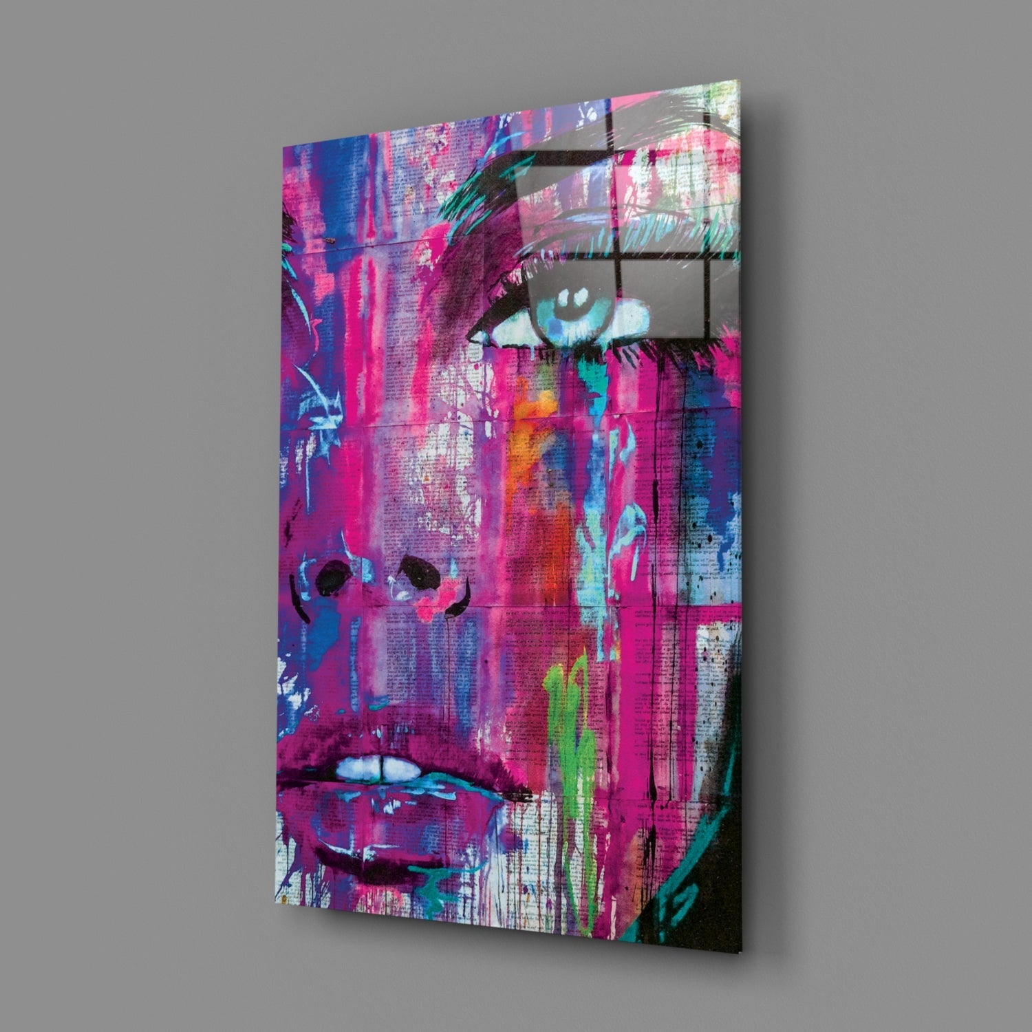 Colorful pop art wall panel featuring a woman's face with vibrant magenta, blue, and neon green paint strokes and text overlay, displayed at an angle against gray background.