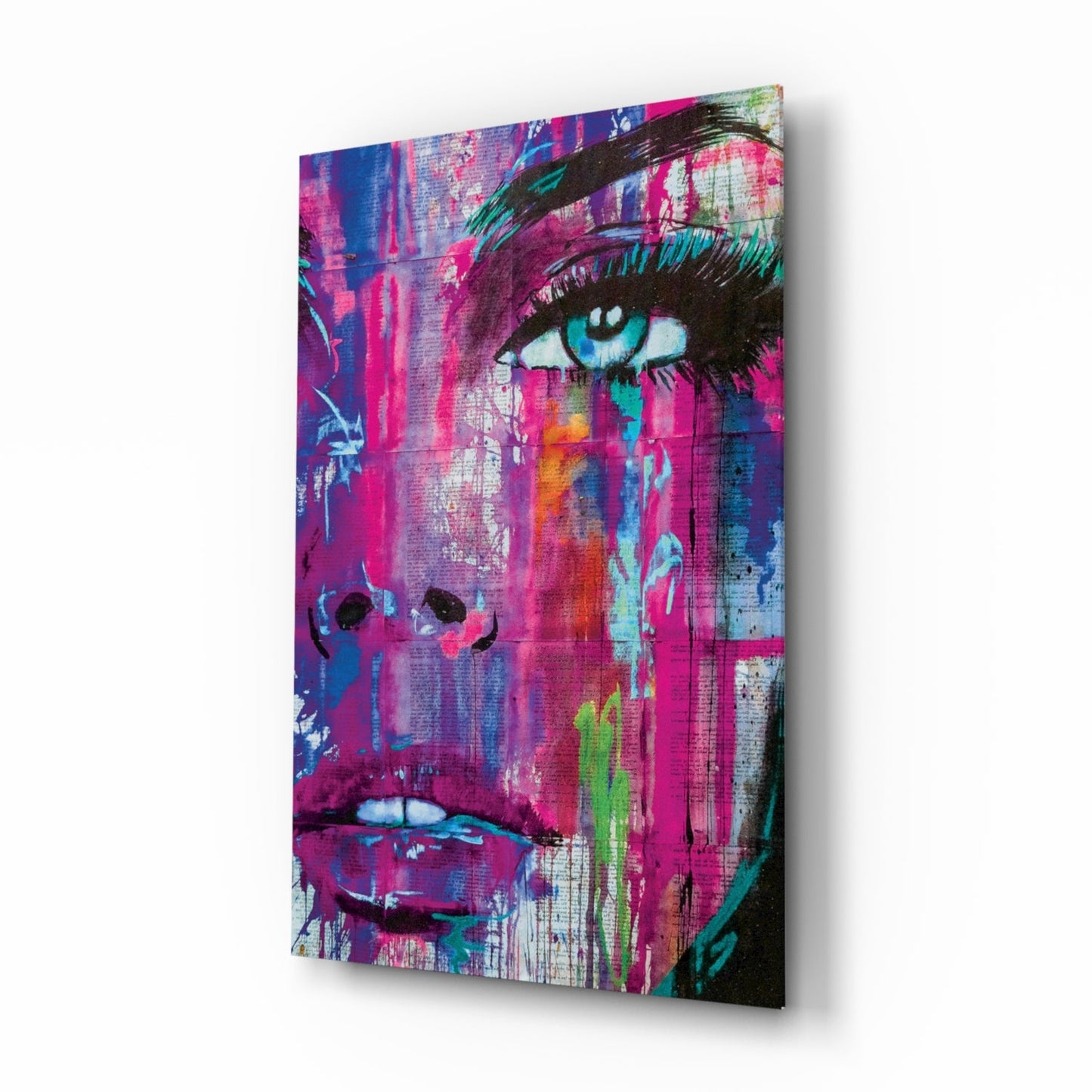 Vibrant pop art canvas featuring a woman's face with blue eyes and magenta tones, displayed at an angle showing depth and shadow.