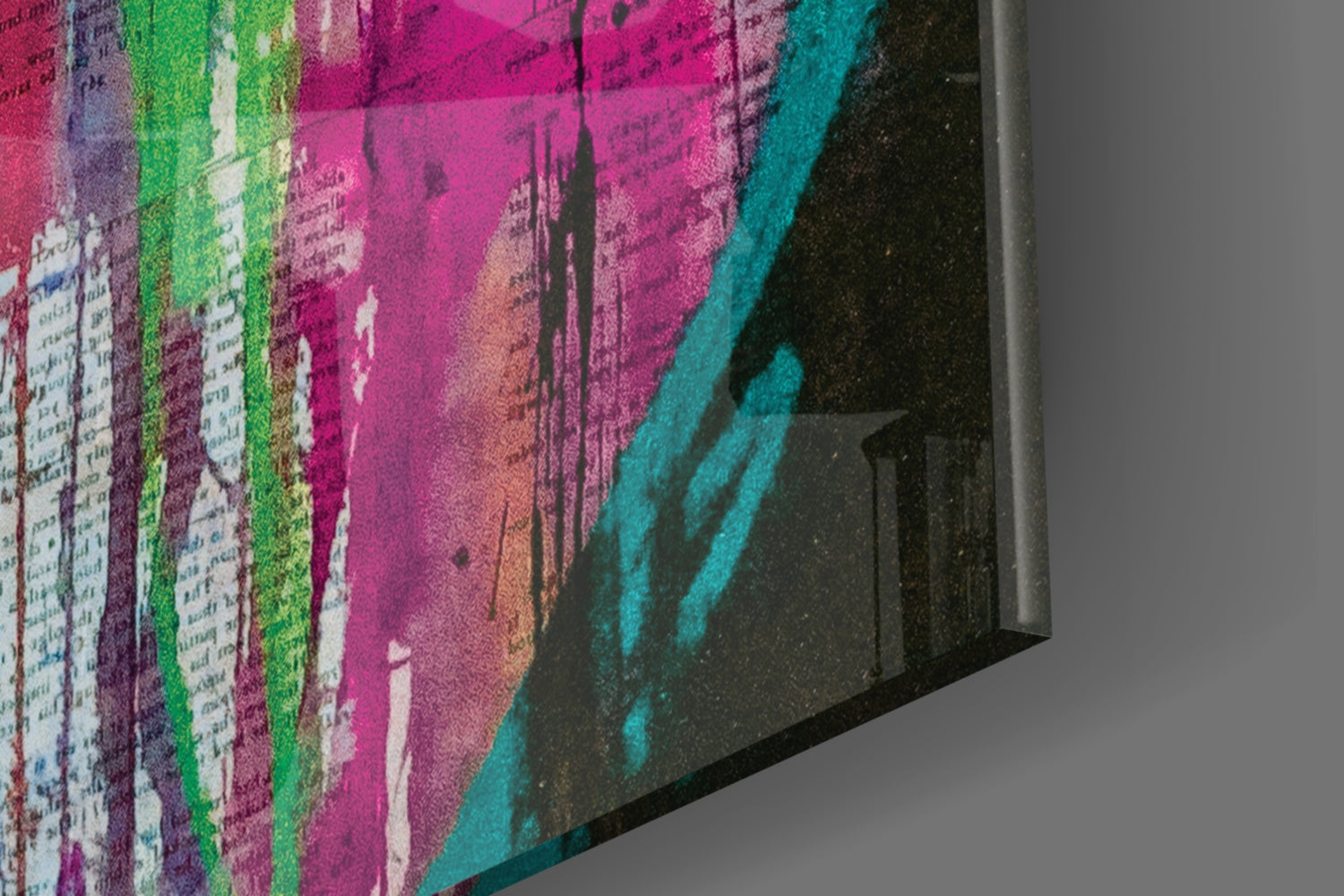 Close-up angled view of colorful wall art canvas showing vibrant pink, green, teal, and black paint strokes with architectural silhouettes and text overlay.
