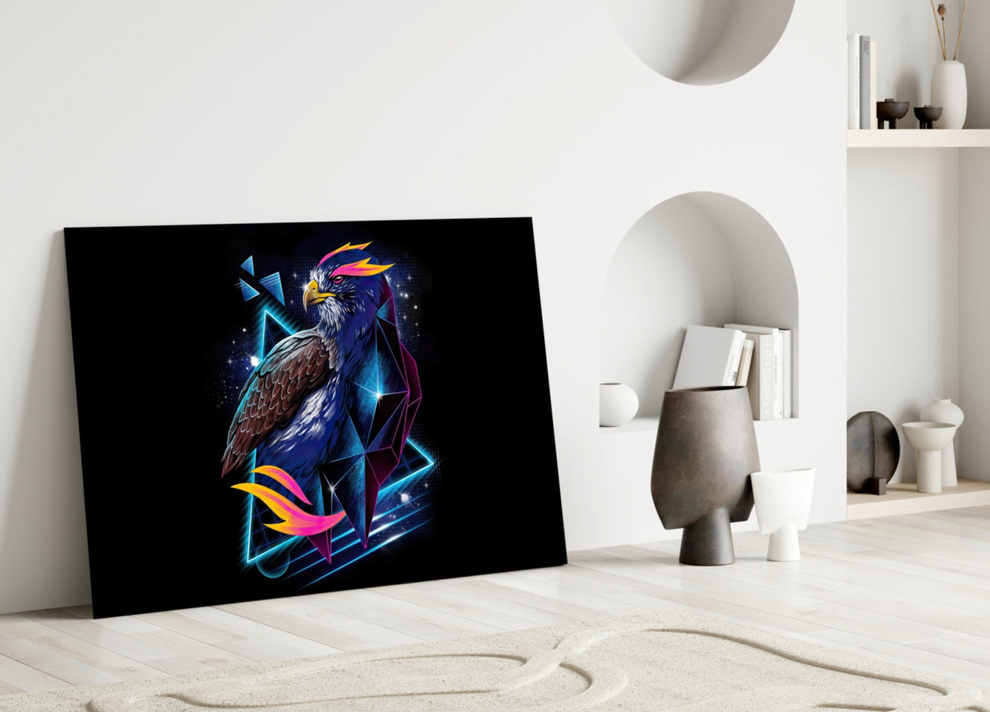 Diamond Hawk Glass Wall Art leaning against white wall in minimalist room, displaying neon blue and pink eagle design on black background.