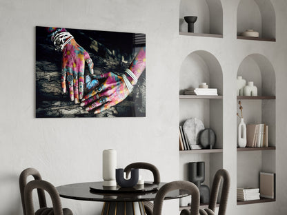 Colorful tattooed hands resting on dark wood displayed as glass wall art above a dining table in modern interior setting.
