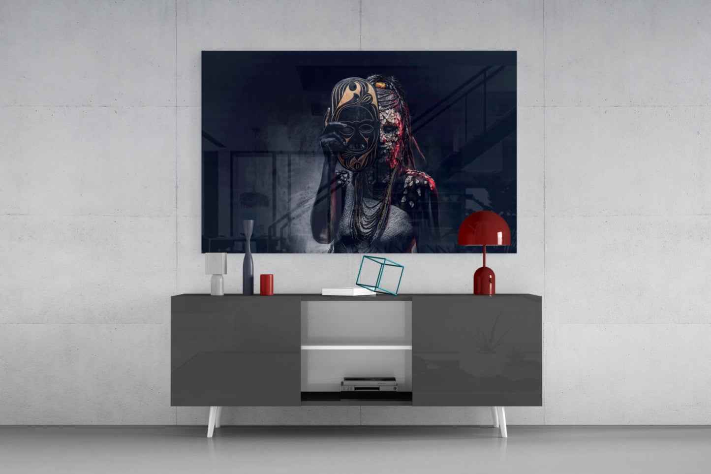 Modern living room with dark gray media console displaying glass wall art of masked figure with gold and red details above television screen.