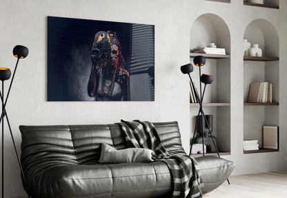 Dark glass wall art depicting a masked figure in dramatic lighting, displayed above a gray leather sofa in a modern living room setting.