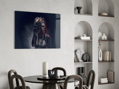 Dark blue glass wall art depicting an ornate masked figure with gold and red details, hung above a black dining table in a modern interior.