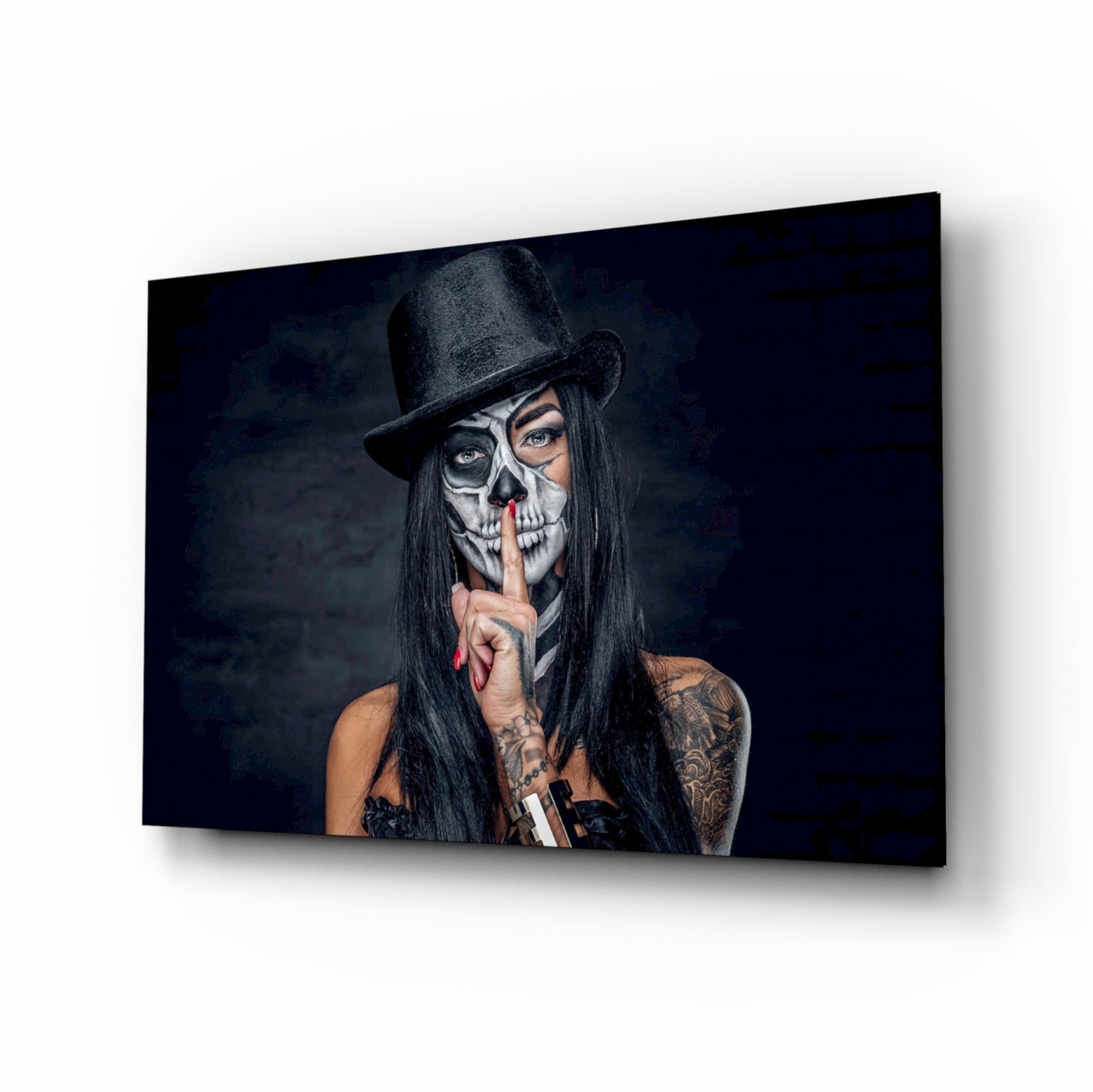 Woman with skull face paint and black hat holding cigarette, displayed on dark glass wall art panel at angle.