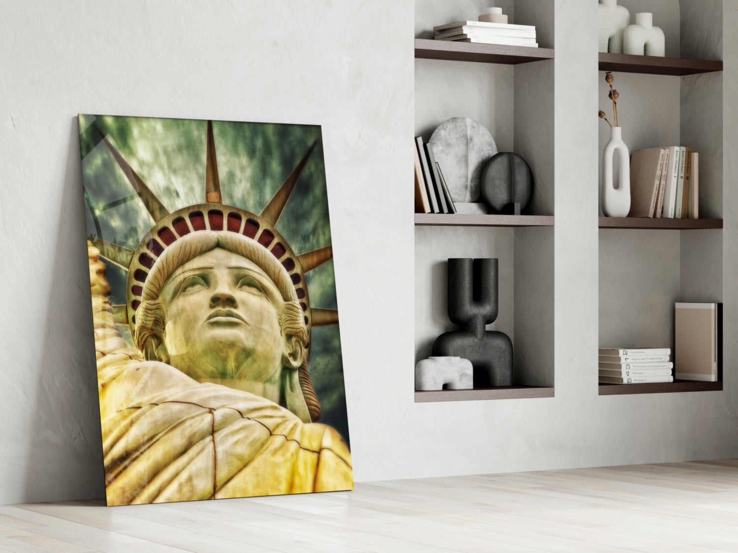 Glass wall art of Statue of Liberty's golden face and crown leaning against white wall beside shelving unit.