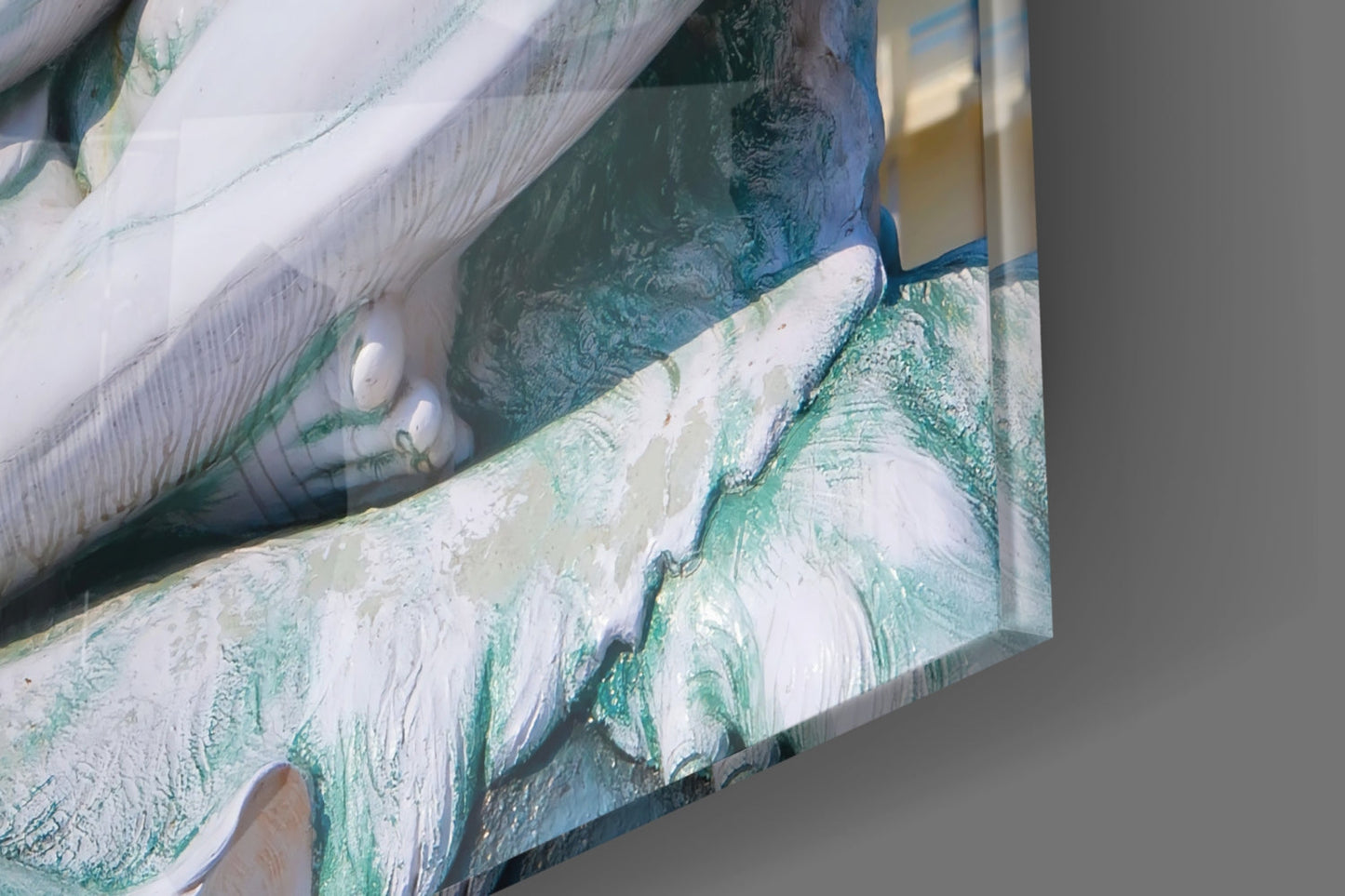 Close-up detail of glass wall art showing white and green painted brushstrokes with oxidized patina effect on textured surface.