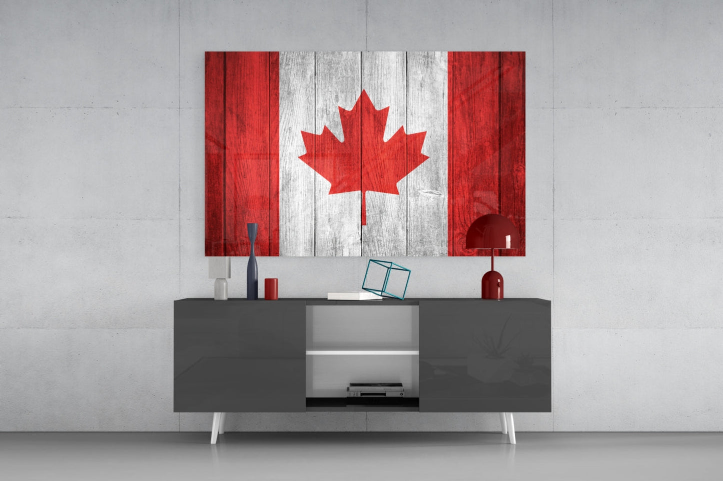 Canadian flag glass wall art displaying red and white maple leaf design mounted above gray media console in modern interior setting.
