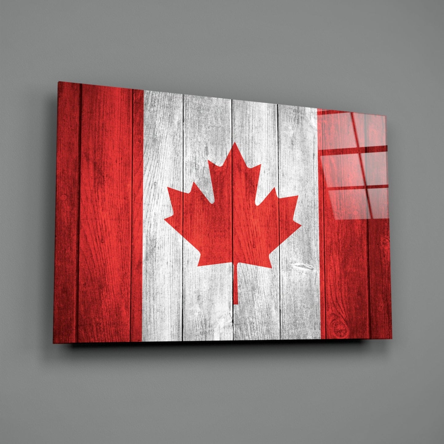 Canadian flag glass wall art displayed at an angle against gray background, showing red and white wooden plank design with maple leaf.