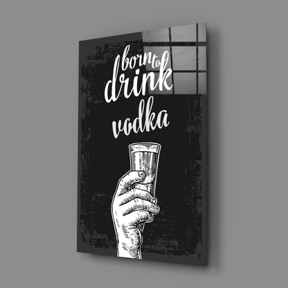 Black canvas wall art with white sketch of hand holding vodka shot glass and cursive text reading "born to drink vodka," displayed at an angle showing depth and shadow.