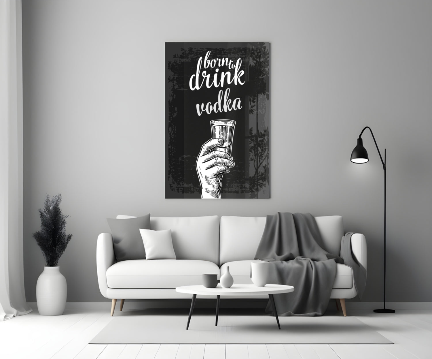 Black canvas with white script text "I born to drink vodka" and hand holding shot glass, displayed above white sofa in modern living room.