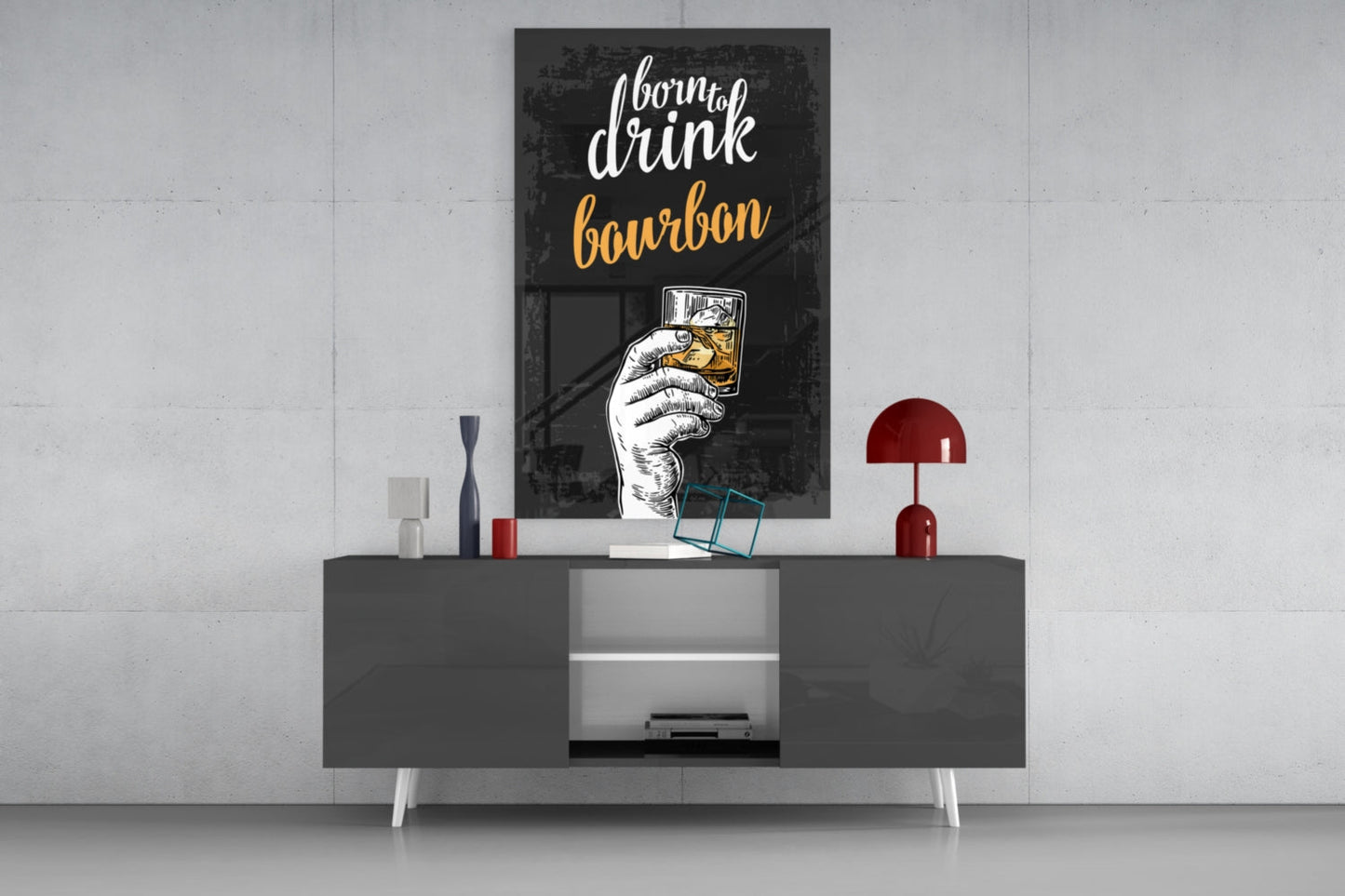 Black framed bourbon wall art with white and gold text displayed above modern gray media console with red lamp and decorative accessories.